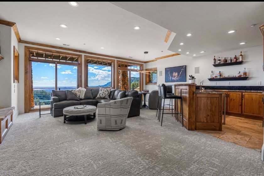 Carpeted modern living room with bar area. 